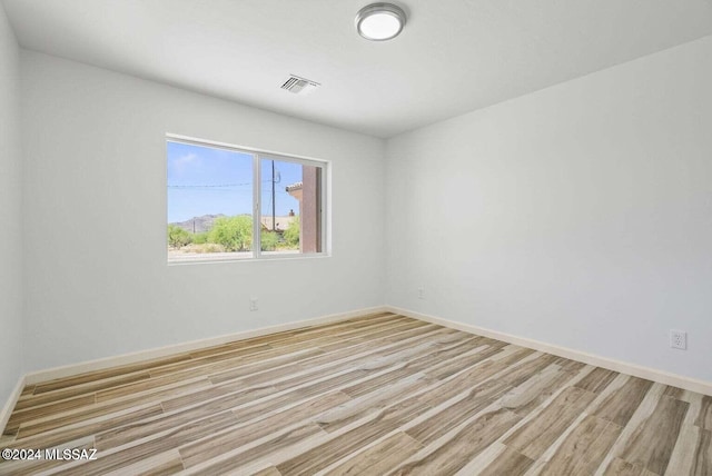 unfurnished room with light hardwood / wood-style floors