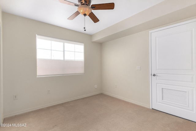 carpeted spare room with ceiling fan