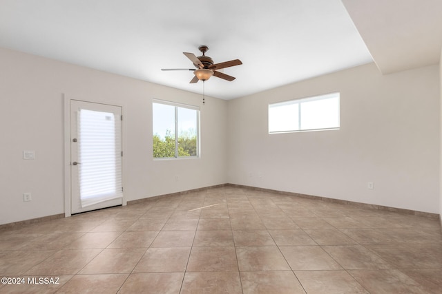 unfurnished room featuring light tile patterned floors and ceiling fan