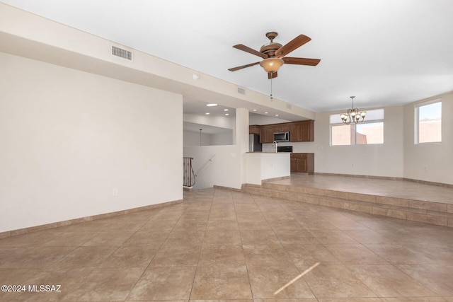 unfurnished living room with ceiling fan with notable chandelier and light tile patterned floors