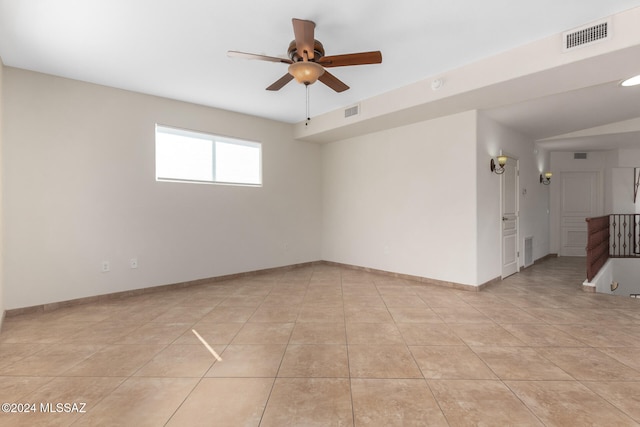 empty room with light tile patterned flooring, ceiling fan, and lofted ceiling