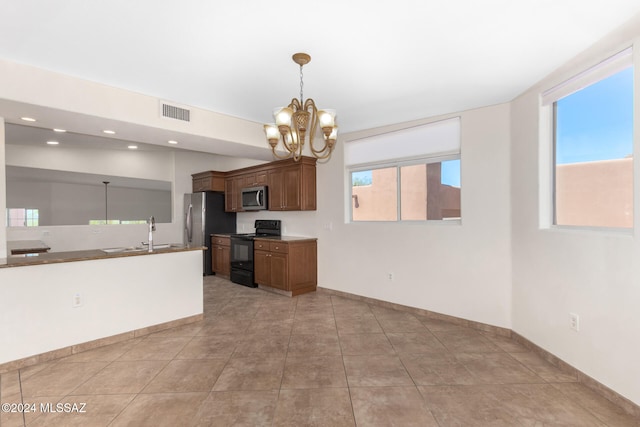 kitchen with pendant lighting, sink, a healthy amount of sunlight, and stainless steel appliances