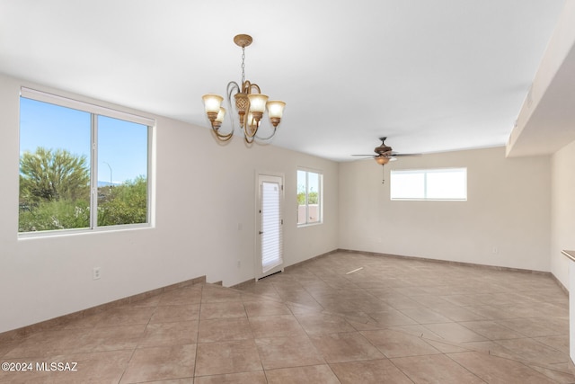 tiled empty room featuring ceiling fan with notable chandelier