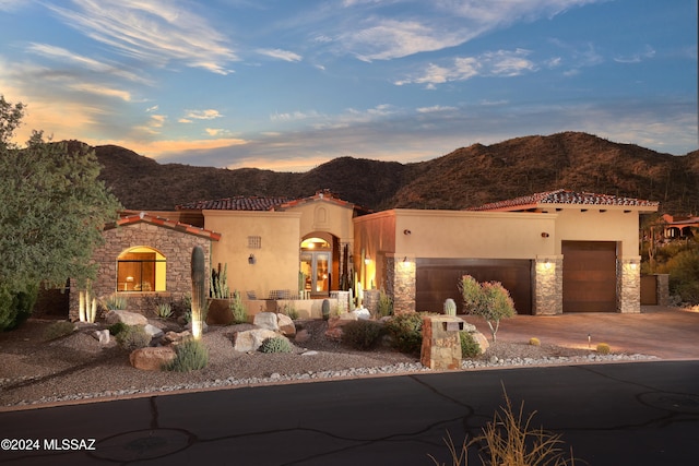 view of front of home with a mountain view and a garage