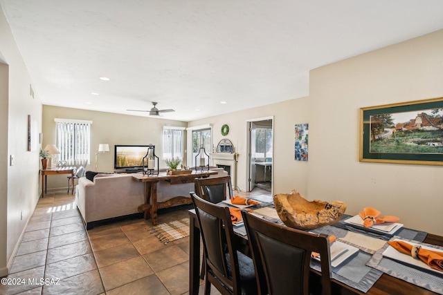 tiled dining room featuring ceiling fan