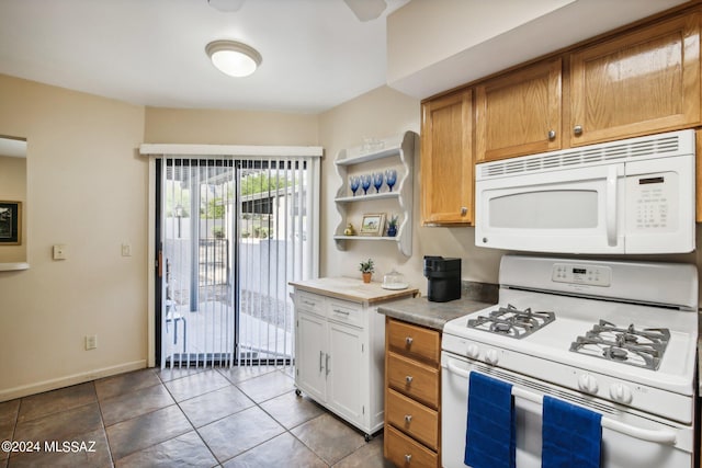 kitchen featuring white appliances and light tile patterned flooring