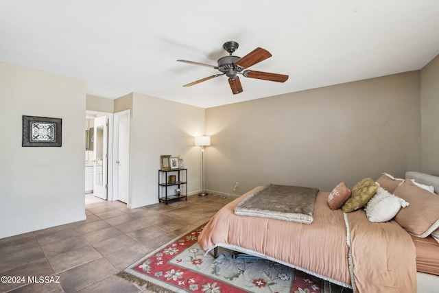 tiled bedroom featuring ceiling fan and connected bathroom