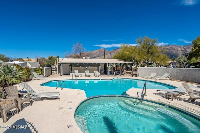 view of swimming pool featuring a patio area and a mountain view