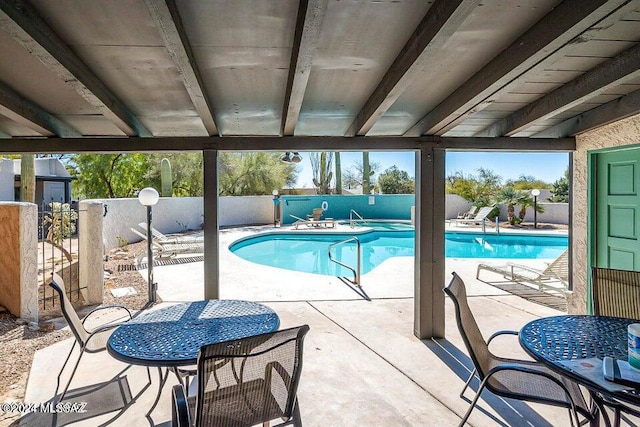 view of swimming pool featuring a patio area