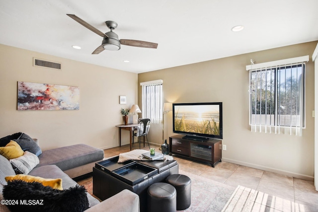 tiled living room with ceiling fan