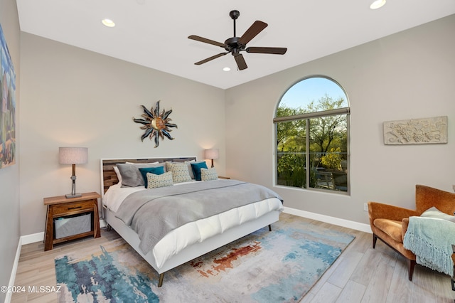 bedroom with light hardwood / wood-style flooring and ceiling fan