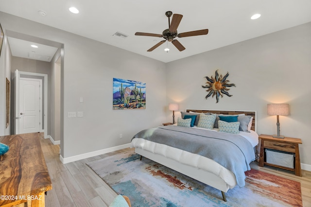 bedroom featuring light hardwood / wood-style flooring and ceiling fan