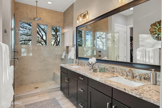 bathroom with hardwood / wood-style flooring, vanity, and an enclosed shower