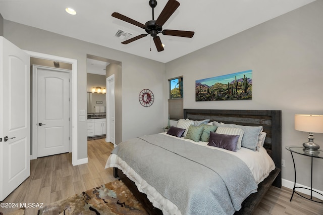 bedroom with ensuite bathroom, ceiling fan, and wood-type flooring