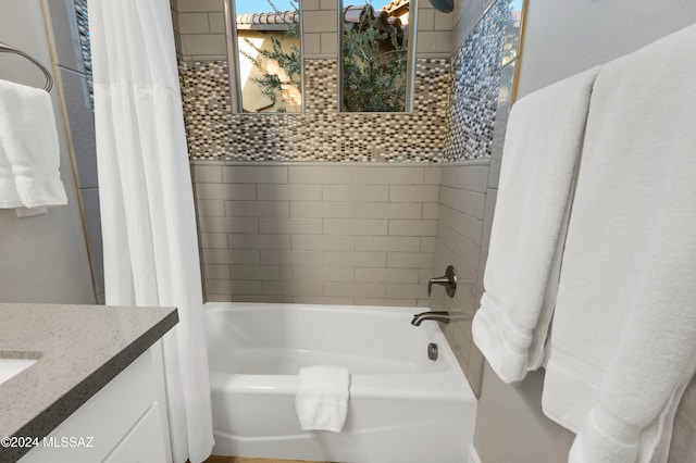 bathroom featuring vanity and shower / bathtub combination with curtain