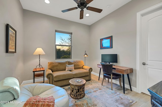 living room with ceiling fan and light hardwood / wood-style flooring