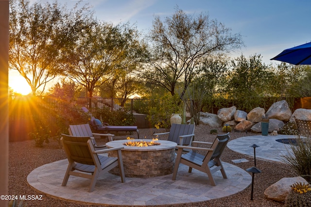 patio terrace at dusk with an outdoor fire pit