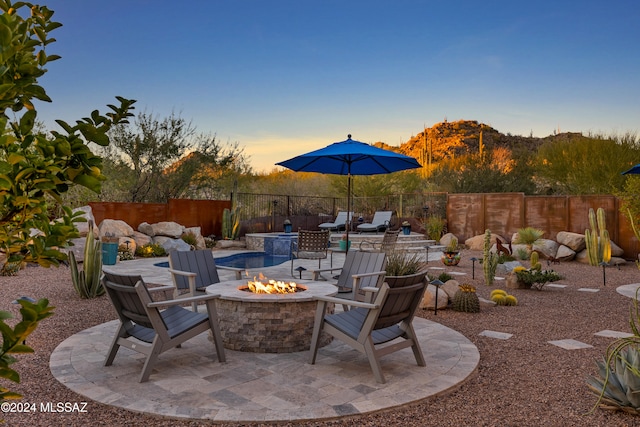 patio terrace at dusk with a fire pit