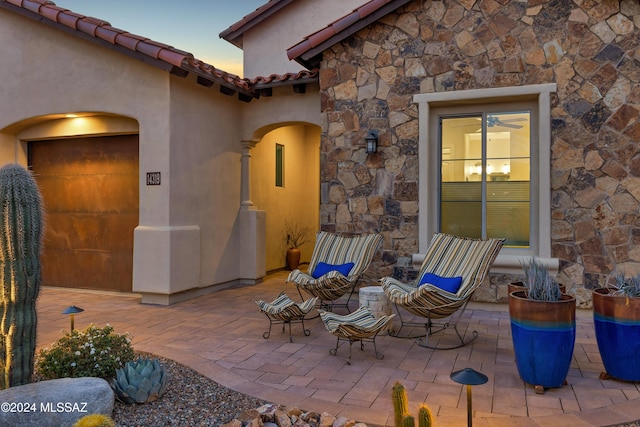 view of patio terrace at dusk