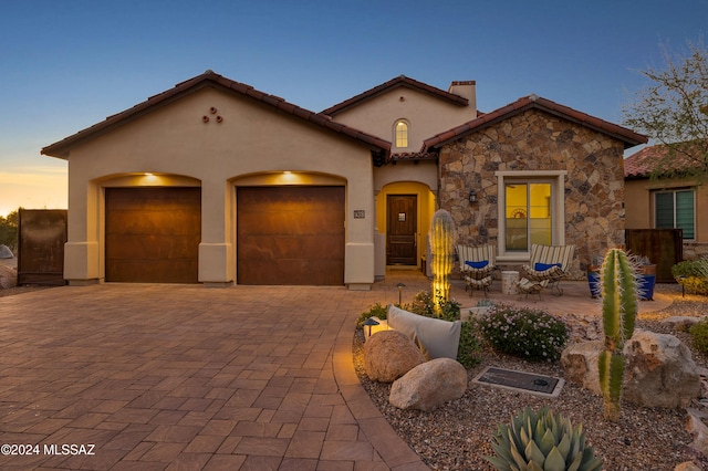 mediterranean / spanish house featuring a garage