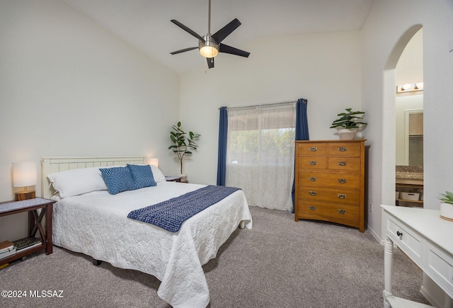 carpeted bedroom featuring ensuite bathroom, high vaulted ceiling, and ceiling fan