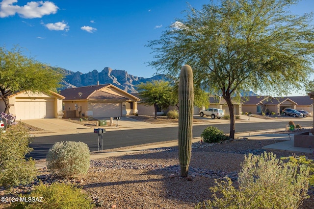 exterior space with a garage and a mountain view