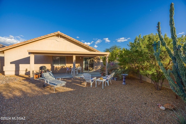 back of house with a patio