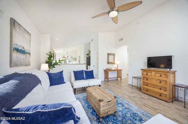 living room featuring ceiling fan and light hardwood / wood-style floors