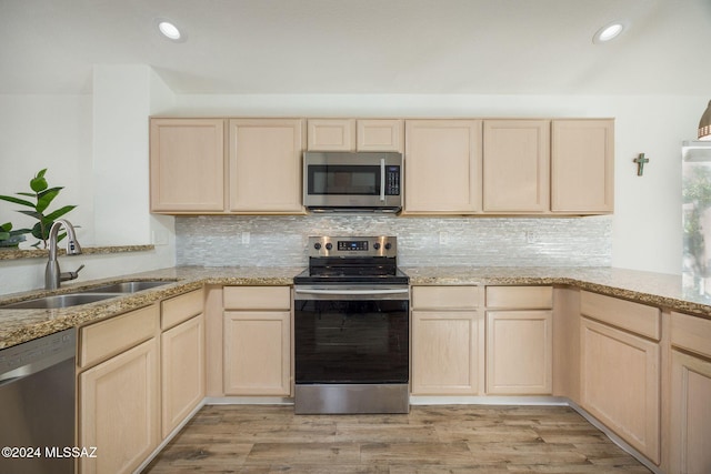 kitchen featuring light brown cabinets, sink, light hardwood / wood-style floors, and stainless steel appliances