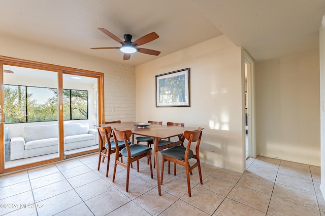 dining room with a ceiling fan and light tile patterned floors