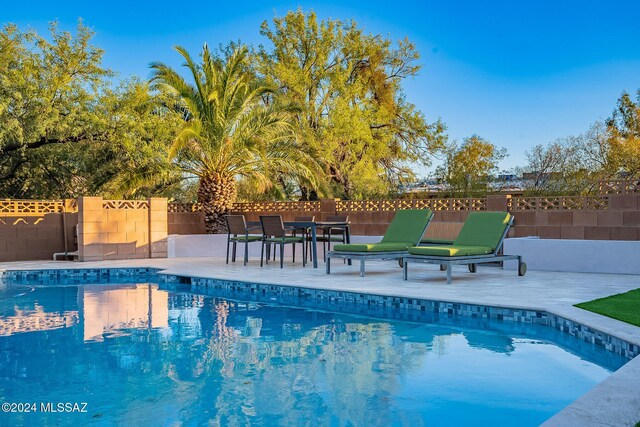 view of swimming pool with a mountain view