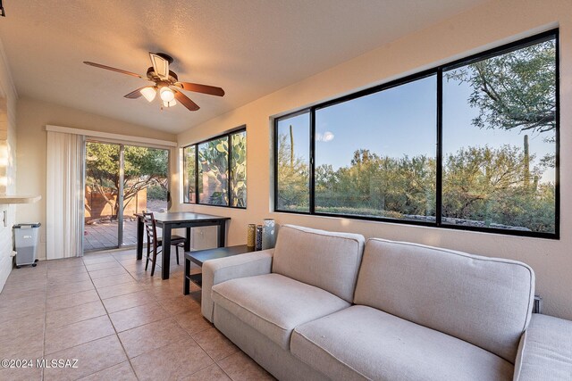 sunroom / solarium featuring lofted ceiling and ceiling fan