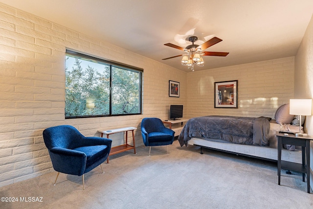 bedroom featuring ceiling fan, brick wall, and carpet flooring