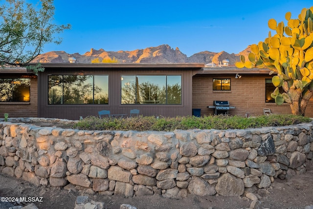 view of home's exterior featuring a mountain view and brick siding