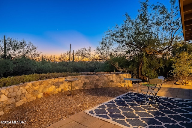 view of patio terrace at dusk