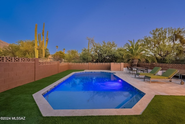 view of pool featuring a yard, a fenced backyard, a fenced in pool, and a patio