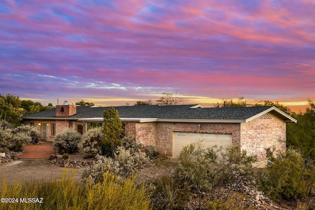 property exterior at dusk featuring a garage