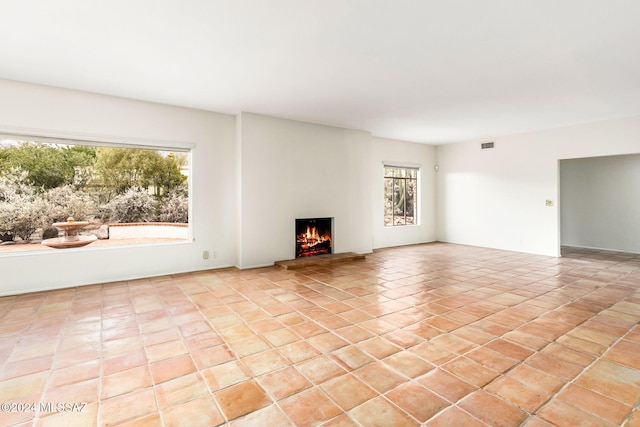 unfurnished living room with light tile patterned floors