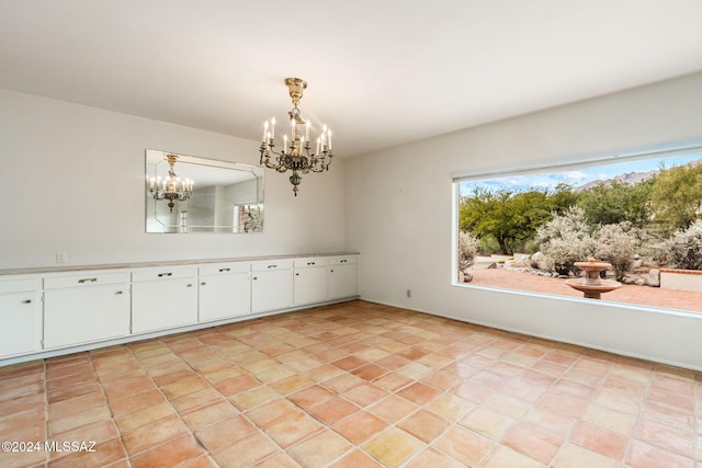 unfurnished dining area with light tile patterned floors and an inviting chandelier