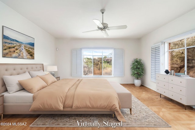 bedroom with light parquet floors and ceiling fan