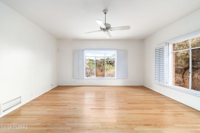 spare room with light wood-type flooring and ceiling fan