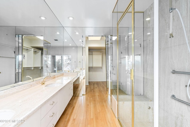 bathroom featuring an enclosed shower, vanity, and hardwood / wood-style flooring