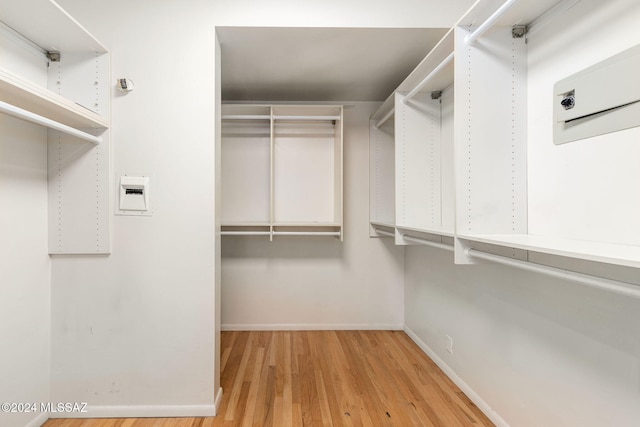 walk in closet featuring light hardwood / wood-style flooring