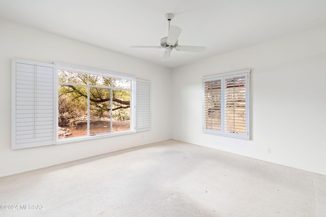 spare room featuring carpet flooring and ceiling fan