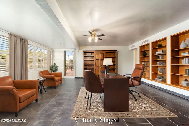 tiled home office featuring ceiling fan