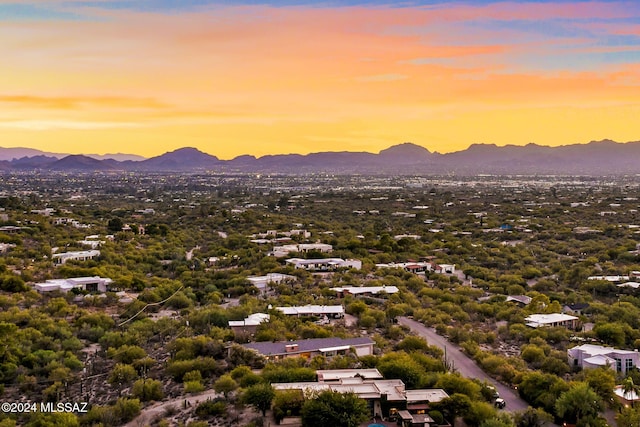 aerial view at dusk featuring a mountain view