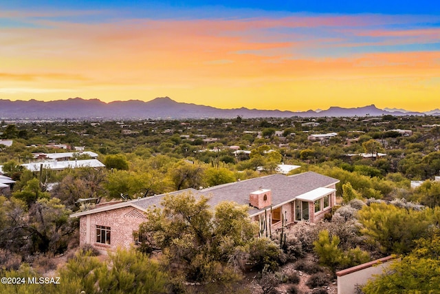 aerial view at dusk featuring a mountain view