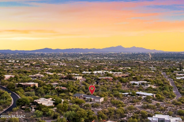 aerial view at dusk featuring a mountain view