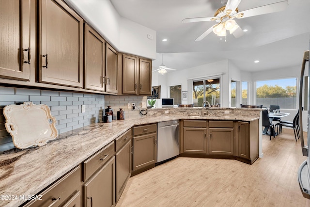 kitchen with decorative backsplash, dishwasher, kitchen peninsula, ceiling fan, and light hardwood / wood-style flooring