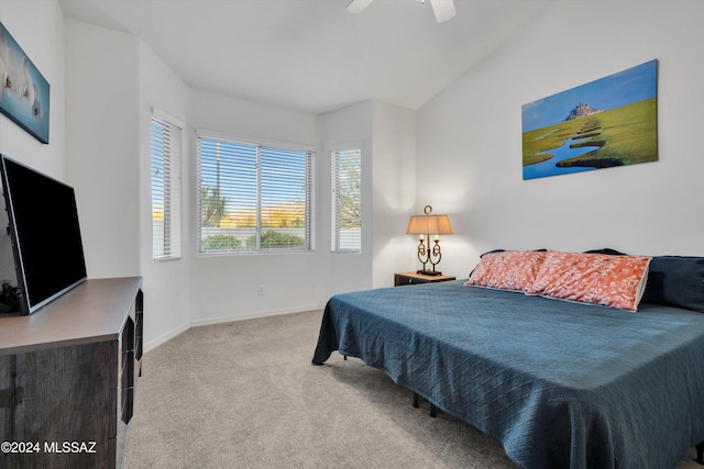 bedroom featuring carpet, vaulted ceiling, and ceiling fan